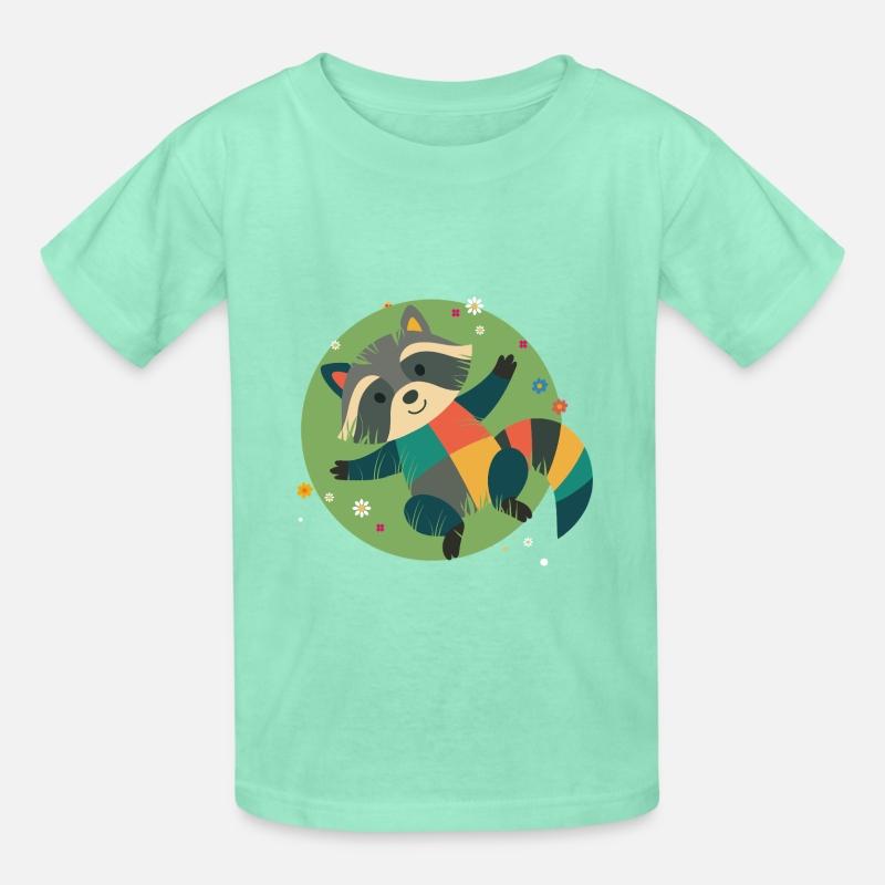 colorful raccoon lies relaxed in the green grass